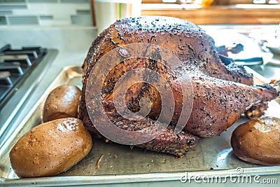 Smoked whole turkey and potatoes on a tray ready for lunch and dinner Stock Photo