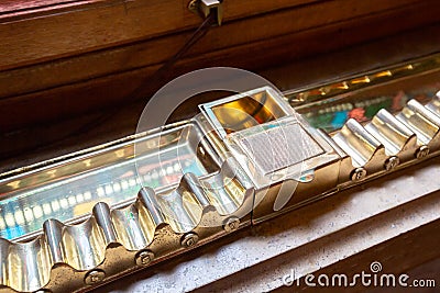 Smokers lounge: Old shelf for storing already lighted cigars in numbered slots and an a Stock Photo