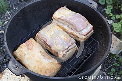 Smoking bacon outdoors Stock Photo