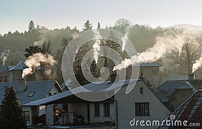 Smoking chimney smoke pollution, small house town Stock Photo