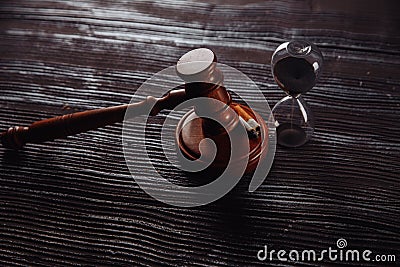 Smoking cigarette, hourglass and wooden judge gavel. Dangerous addiction and law Stock Photo