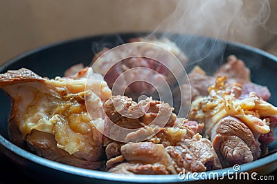 Smoking cuts of meat in a frying pan. The process of cooking meat Stock Photo