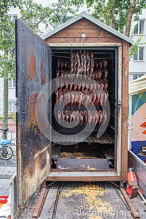 Smoking fish in a smoker in a street traditional market Stock Photo