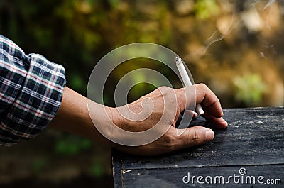 Smoking in the hands of men. Stock Photo