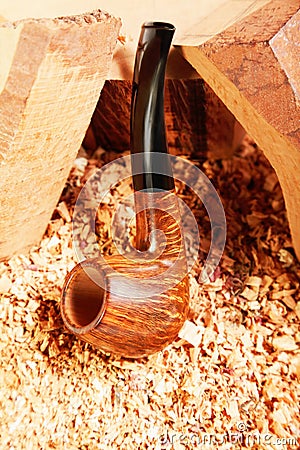 Smoking pipe leaning on wood Stock Photo