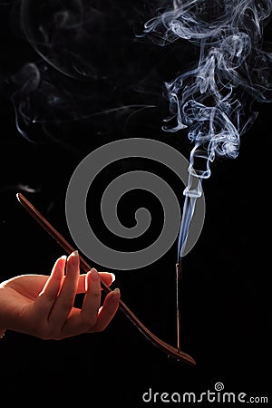 Smoking stick in the woman`s hand Stock Photo