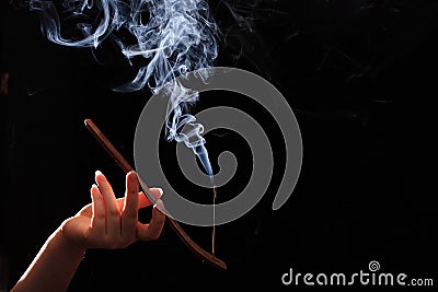 Smoking stick in the woman`s hand Stock Photo