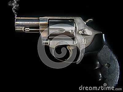 A smoking vintage Smith and Wesson .357 - .38 Special Pistol Handgun Firearm Editorial Stock Photo