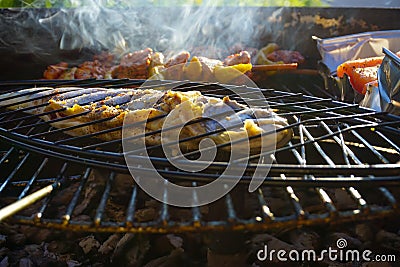 Smoky fish on the grill Stock Photo