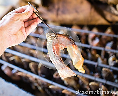 Smoky fish in smokehouse Stock Photo