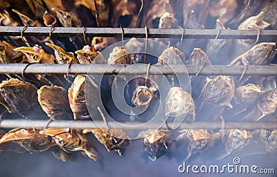 Smoky fish in smokehouse Stock Photo