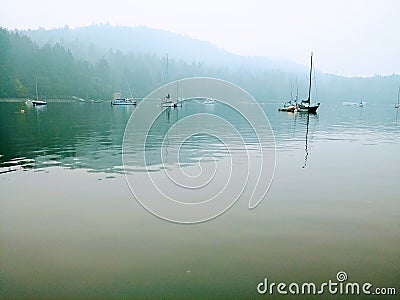 Sailboat in the mist. Stock Photo