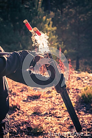 Smoky Shotgun Shells Ejection Stock Photo