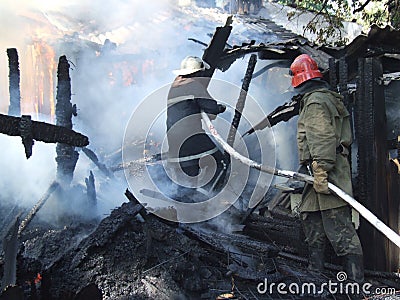 Firefighters extinguish a fire in an apartment house Stock Photo