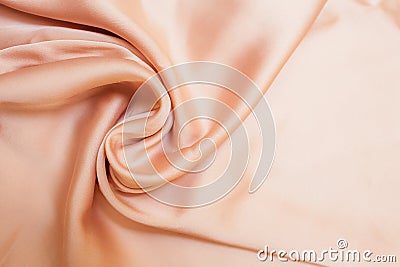 Smooth biege fabric cloth texture with folds and wawes. Close up Abstract background. Biege drapped silk Stock Photo