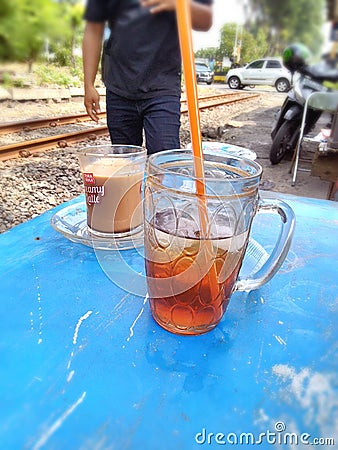 Smooth blurry photos, iced tea and a cup of coffee, perfect for a hot meal during the day Editorial Stock Photo