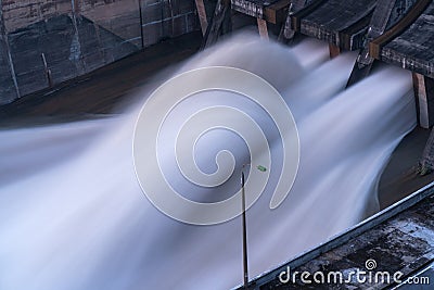 Smooth draining water from the hydroelectric dam at dawn Stock Photo