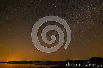 Smooth surface of the lake on background the starry sky Stock Photo