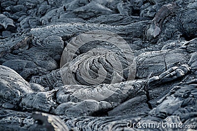 Smooth, undulating surface of frozen pahoehoe lava. Frozen lava wrinkled in tapestry-like folds and rolls resembling twisted rope Stock Photo