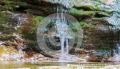 Smooth waterfall on a rock full of moss Stock Photo