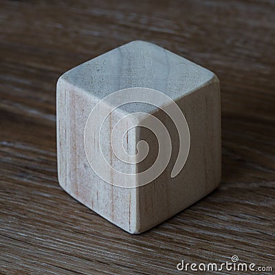 A smooth wooden cube showing three sides with copy space Stock Photo