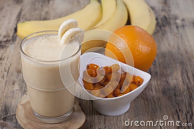 Smoothie of banana, orange juice , frozen sea-buckthorn with y Stock Photo