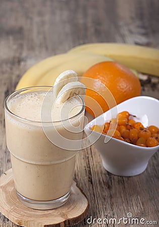 Smoothie of banana, orange juice , frozen sea-buckthorn with y Stock Photo