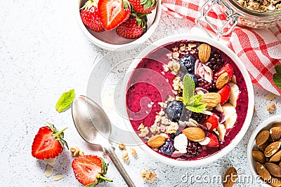 Smoothie bowl from fresh berries, nuts and granola. Stock Photo