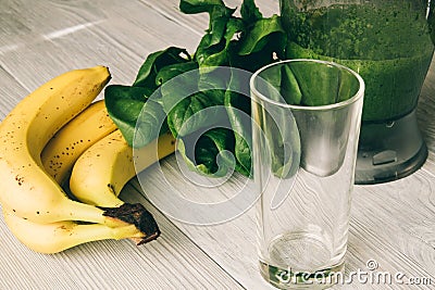 Smoothies in the food processor, empty glass, banana and spinach Stock Photo
