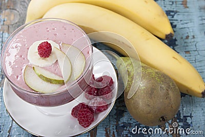 Smoothies of pear, banana and frozen raspberries with yogurt. Stock Photo