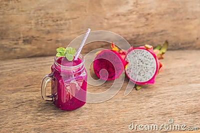 Smoothies of a red organic dragon fruit on an old wooden background Stock Photo