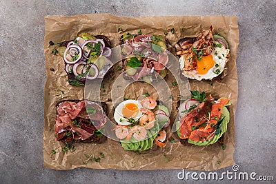 Smorrebrod, traditional Danish open sanwiches, dark rye bread with different topping Stock Photo