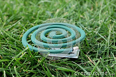 Smouldering insect repellent coil on grass outdoors Stock Photo