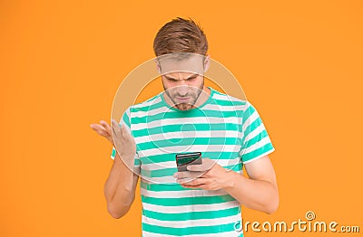 SMS mobile communication. Handsome man read on mobile phone. Mobile news. Handheld mobile device. Touchscreen interface Stock Photo
