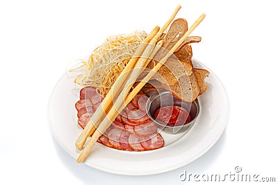 Snack for beer. Sausages, crackers, cheese and sauce on plate Stock Photo
