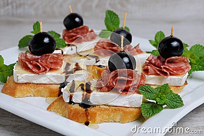 Snack with Cheese Brie and salami Stock Photo