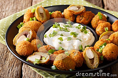 Snack fried green olives stuffed with almonds close-up. horizontal Stock Photo