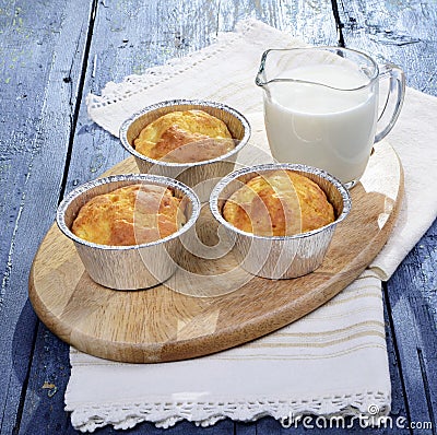 Snack muffins,salty snack cakes muffins with cheese on a wooden plate,a glass of fresh milk Stock Photo