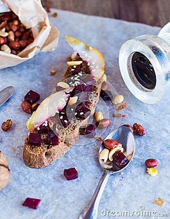 Snack sandwich with roasted beets, nuts, pear and sesame Stock Photo