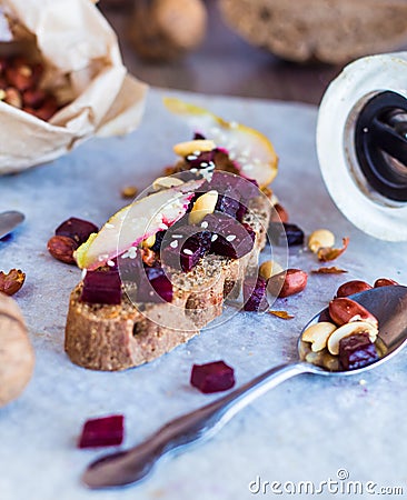 Snack sandwich with roasted beets, nuts, pear and sesame Stock Photo