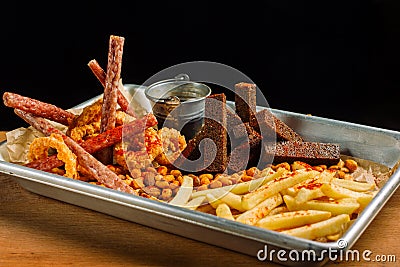 Snack to beer. Beer metal tray with a mountain of food. Stock Photo
