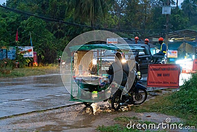A snack vendor on a bike selling food in the rain Editorial Stock Photo