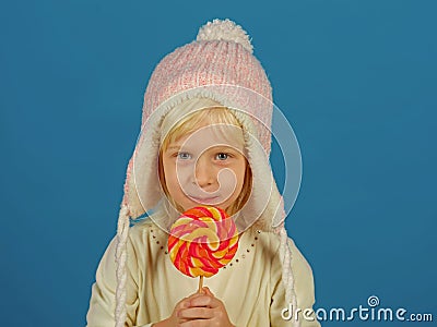 Snack on when you please. Little child with sweet lollipop. Little girl hold lollipop on stick. Happy candy girl. Happy Stock Photo
