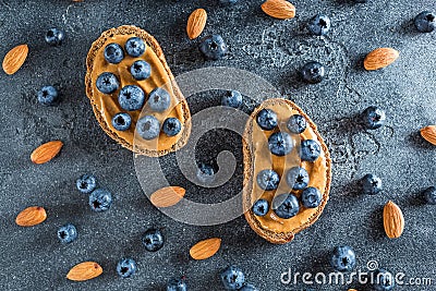 Snacks with bread, peanut butter and blueberries. Healthy food concept. Flat lay, top view Stock Photo