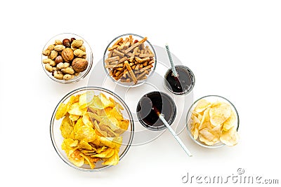 Snacks for TV watching. Chips, nuts, soda, rusks on white background top view Stock Photo