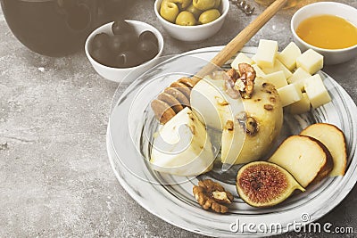 Snacks with wine - various types of cheeses, figs, nuts, honey, Stock Photo
