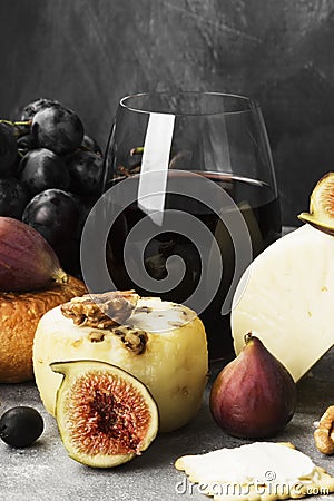 Snacks with wine - various types of cheeses, figs, nuts, honey, Stock Photo