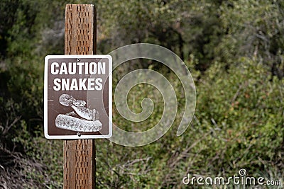 Snake caution sign at remote camping location Stock Photo