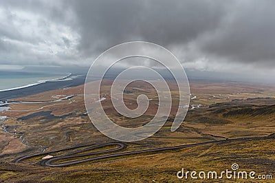 Snake Road in Iceland. Landscape. Cloudy Blue Sky. Ocean. Stock Photo