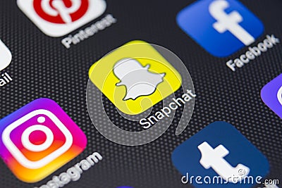 Snapchat application icon on Apple iPhone 8 smartphone screen close-up. Snapchat app icon. Snapchat is an online social networking Editorial Stock Photo